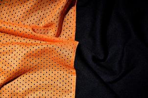 Close up of orange polyester nylon sportswear shorts to created a textured background photo