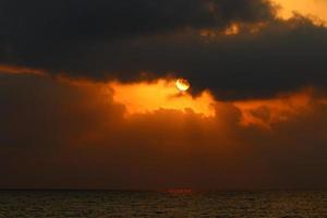 The sun sets below the horizon on the Mediterranean Sea in northern Israel. photo