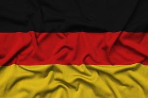 Germany flag is depicted on a sports cloth fabric with many folds. Sport team banner photo