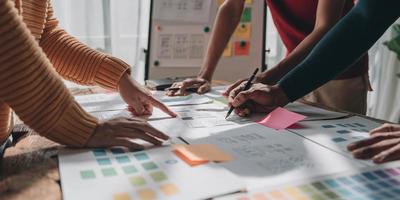 Team ux designer creative graphic planning application development a prototype smartphone layout. photo