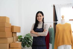 Startup small business entrepreneur SME, asian woman packing box. Portrait of young Asian small business owner in home office, online sell marketing delivery, SME e-commerce telemarketing concept photo
