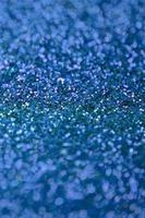 Blue decorative sequins. Background image with shiny bokeh lights from small elements photo