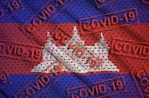 Cambodia flag and many red Covid-19 stamps. Coronavirus or 2019-nCov virus concept photo