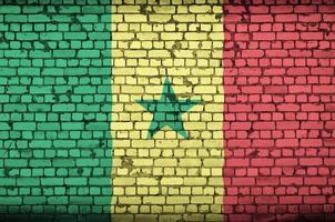 Senegal flag is painted onto an old brick wall photo