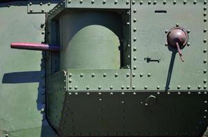 The texture of the wall of the tank, made of metal and reinforced with a multitude of bolts and rivets. Images of the covering of a combat vehicle from the Second World War with a guided machine gun photo