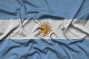 Argentina flag is depicted on a sports cloth fabric with many folds. Sport team banner photo