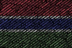 Gambia flag is depicted on the screen with the program code. The concept of modern technology and site development photo