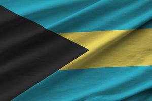 Bahamas flag with big folds waving close up under the studio light indoors. The official symbols and colors in banner photo