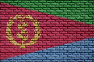 Eritrea flag is painted onto an old brick wall photo