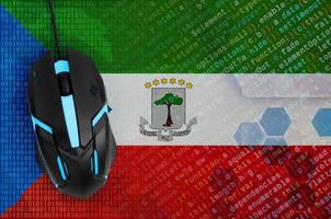 Equatorial Guinea flag and computer mouse. Digital threat, illegal actions on the Internet photo