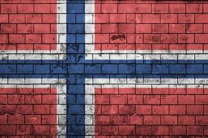 Norway flag is painted onto an old brick wall photo