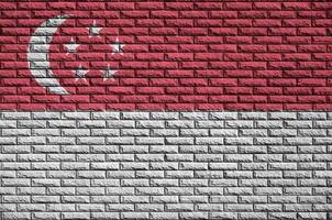 Singapore flag is painted onto an old brick wall photo