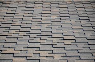 Modern roofing and decoration of chimneys. Flexible bitumen or slate shingles photo