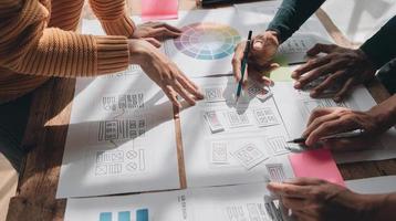 Team ux designer creative graphic planning application development a prototype smartphone layout. photo