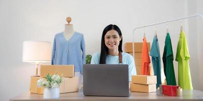 Young woman small business owner working at home office. Online marketing packaging delivery, startup SME entrepreneur or freelance woman concept. Small business owener photo
