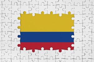 Colombia flag in frame of white puzzle pieces with missing central part photo