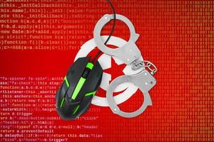 Tunisia flag and handcuffed computer mouse. Combating computer crime, hackers and piracy photo