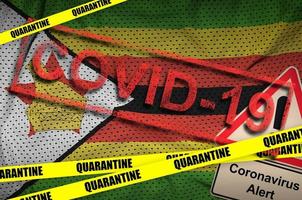Zimbabwe flag and Covid-19 quarantine yellow tape with red stamp. Coronavirus or 2019-nCov virus photo