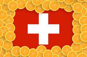 Switzerland flag in fresh citrus fruit slices frame photo