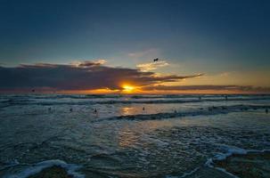 Sunset on the beach in Denmark. Waves rolling over the sand. Walk on the coast photo