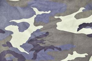 Texture of fabric with a camouflage painted in colors of the marsh. Army background image photo