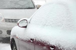 Fragments of parked cars covered with snow photo