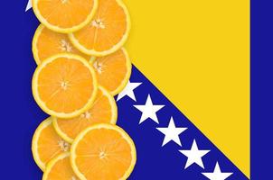 Bosnia and Herzegovina flag and citrus fruit slices vertical row photo