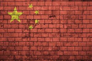 China flag is painted onto an old brick wall photo
