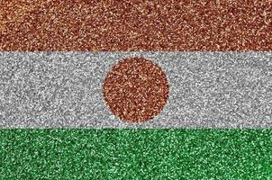Niger flag depicted on many small shiny sequins. Colorful festival background for party photo