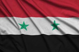 Syria flag is depicted on a sports cloth fabric with many folds. Sport team banner photo