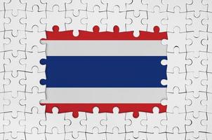 Thailand flag in frame of white puzzle pieces with missing central part photo