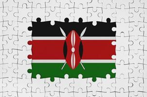 Kenya flag in frame of white puzzle pieces with missing central part photo