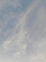 The view of the sky before sunset with the moon in sight photo