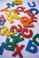 multi colored wooden letters on the white background photo