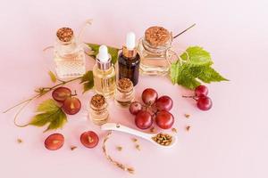a set of cosmetics in various glass bottles based on organic grape seed oil. the fountain of youth. natural cosmetics. photo