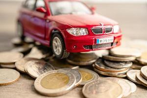 Bangkok, Thailand - October 14, 2022 Car on coins background Car loan, Finance, saving money, insurance and leasing time concepts. photo