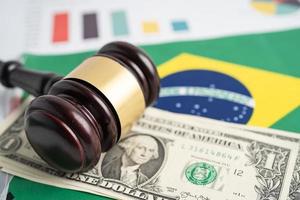 Gavel on Brazil flag with graph and US dollar banknotes  for judge lawyer. Law and justice court concept. photo