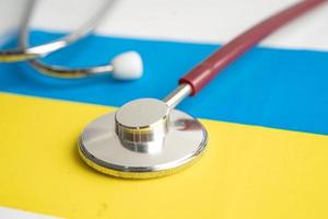 Black stethoscope on Ukraine flag background, Business and finance concept. photo