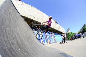 KHARKIV, UKRAINE - 27 MAY, 2018 Freestyle BMX riders in a skatepark during the annual festival of street cultures photo