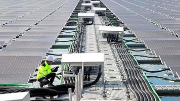 el retrato de un joven ingeniero asiático revisa los paneles solares fotovoltaicos. concepto. servicio de electricidad de tecnología de energía renovable, energía verde video