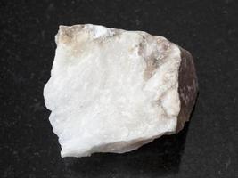 raw Anhydrite stone on dark background photo
