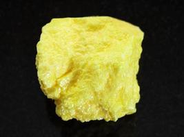 raw native Sulphur stone on dark background photo