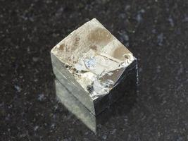 rough pyrite crystal on dark background photo