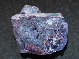 rough Cuprite stone on dark background photo