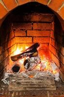 ash, coal and burning wooden logs in fireplace photo