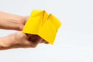 Hand in a paper fortune teller isolated on white background. photo