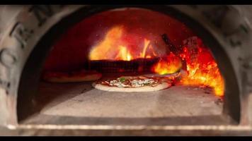 A pizza being baked in an old wood-fired oven video