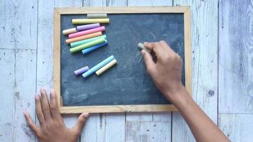 Writing on blackboard with chalk video