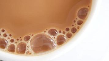 Cup of coffee or black tea with milk close up video