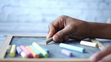 Writing with chalk on a blackboard video